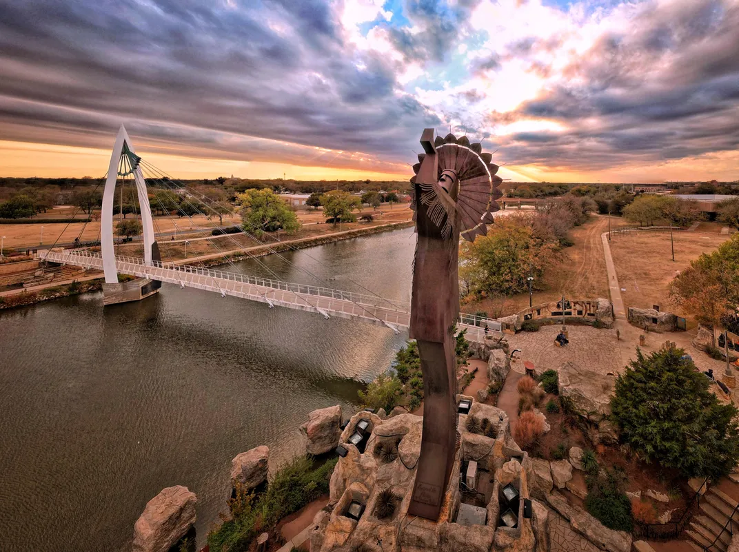 the Keeper of the Plains steel statue stands at the confluence of the Arkansas and Little Arkansas rivers in Wichita