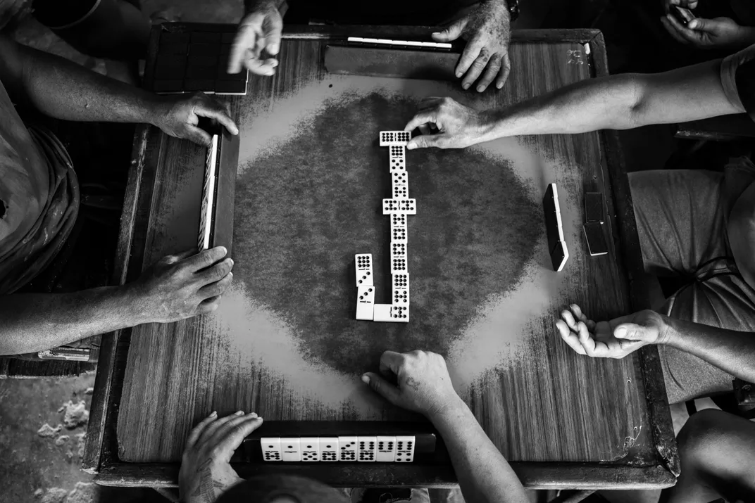 Men play dominoes