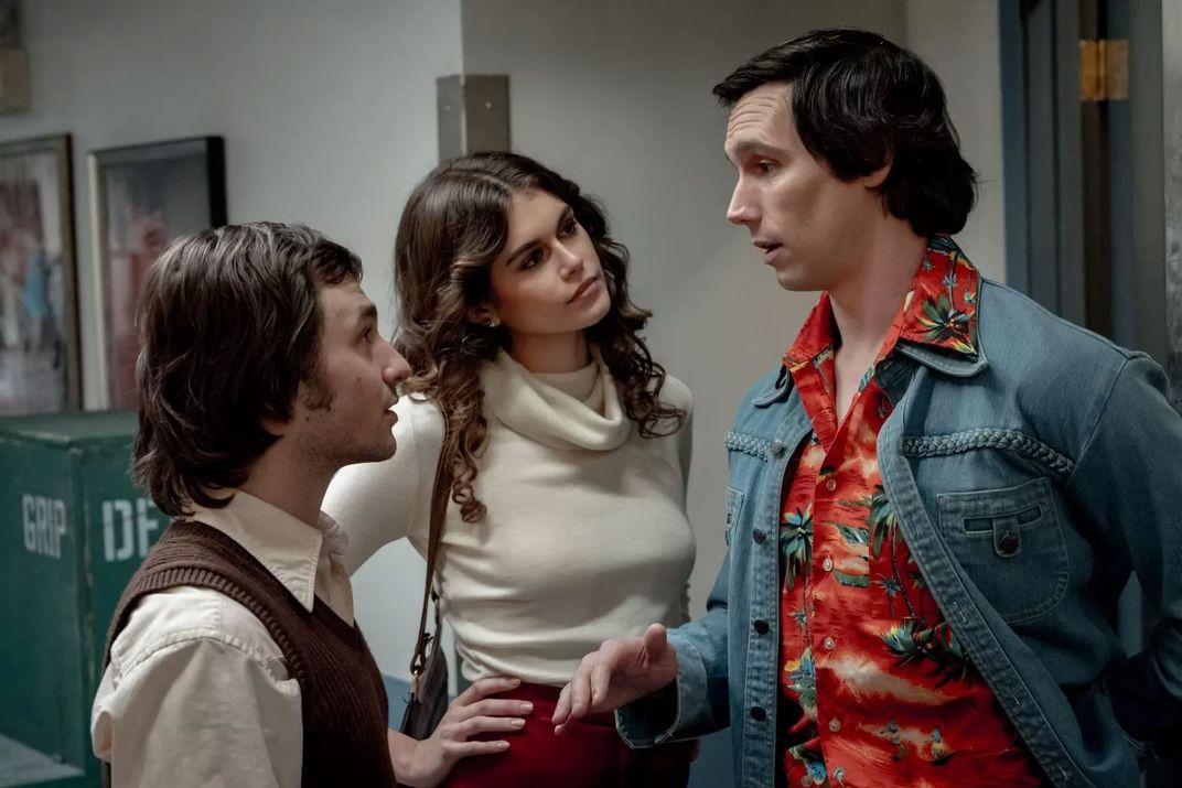 L to R: Gabriel LaBelle as Lorne Michaels, Kaia Gerber as Jacqueline Carlin and Cory Michael Smith as Chevy Chase in Saturday Night