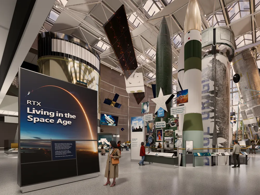 a view of a museum exhibit with a large rocket booster at the center