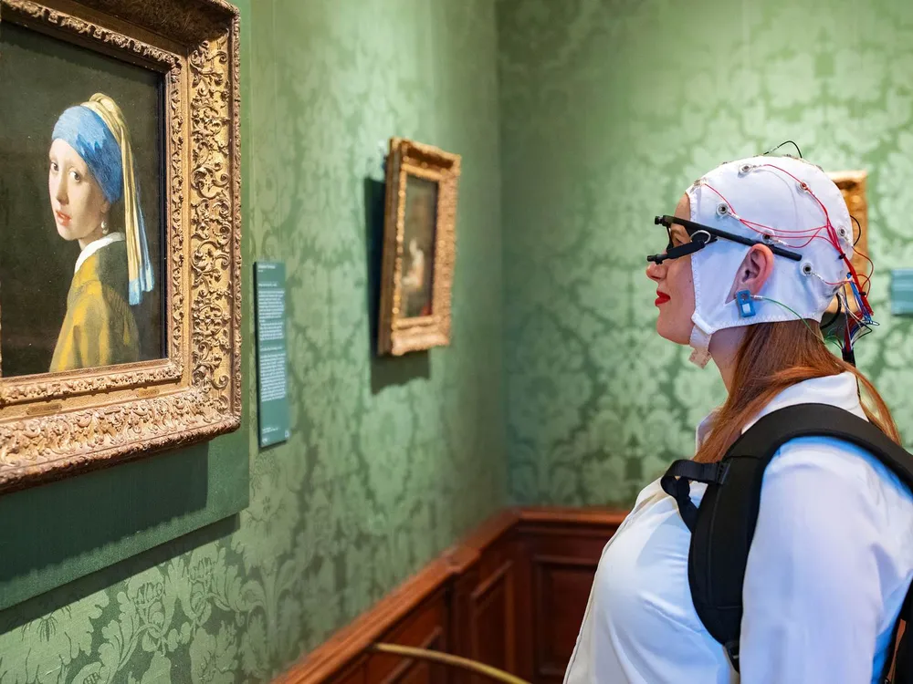 Woman looks at painting