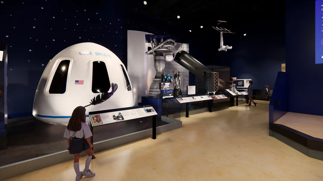 a museum exhibit showing a white crew capsule behind a descriptive sign