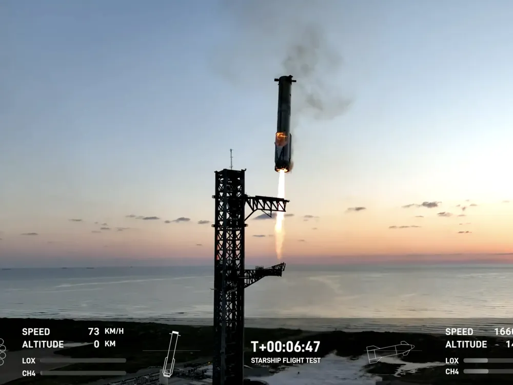 The Super Heavy booster returning to the launch tower